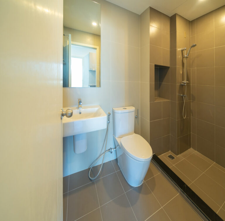 Toilet. bathroom doors in restroom in condominium apartment or hotel. Empty interior decoration design